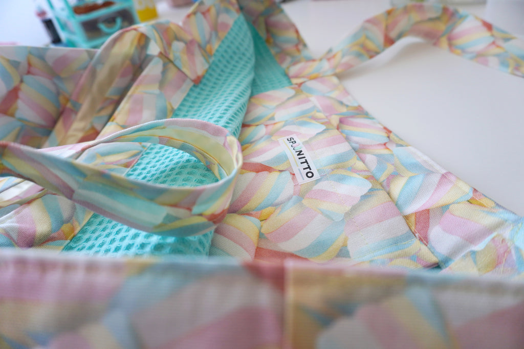Colorful tote bag with marshmallow pattern and a visible SPOONITTO brand logo on a light background