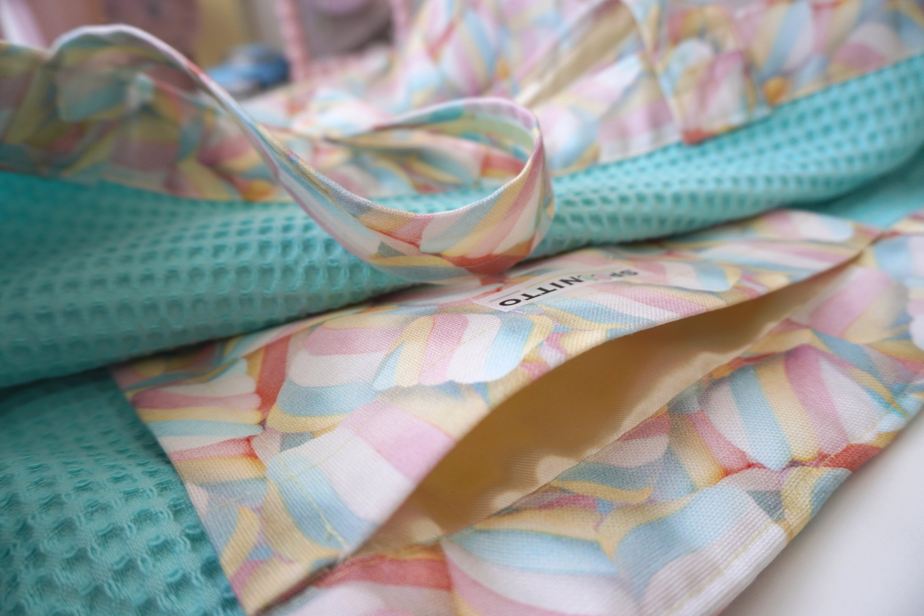 Colorful marshmallow printed fabric with a pocket on a waffle textured lining