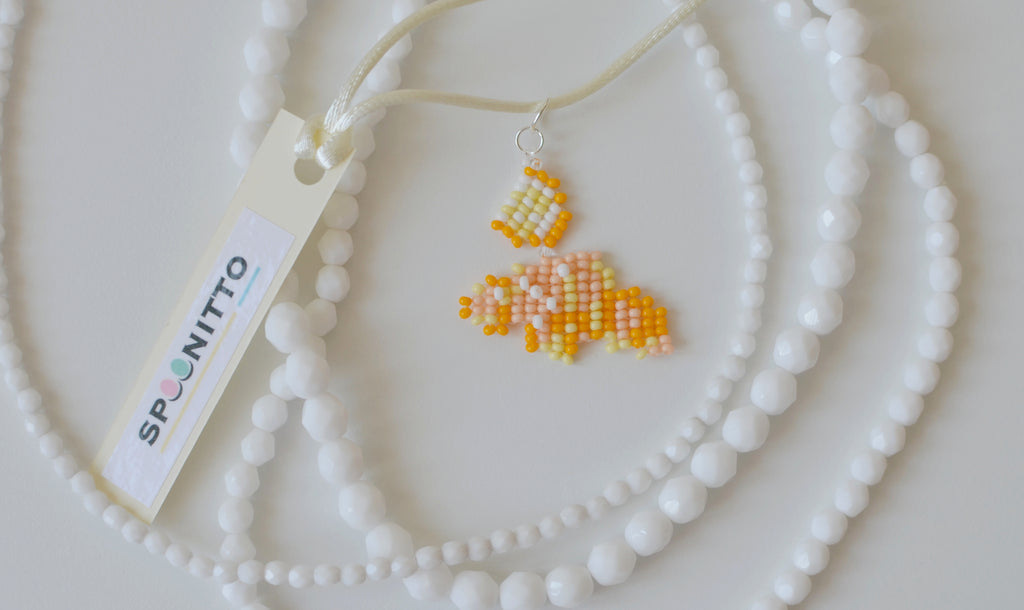 Handmade beaded cornetto necklace with a SPOONITTO brand card on a white background.