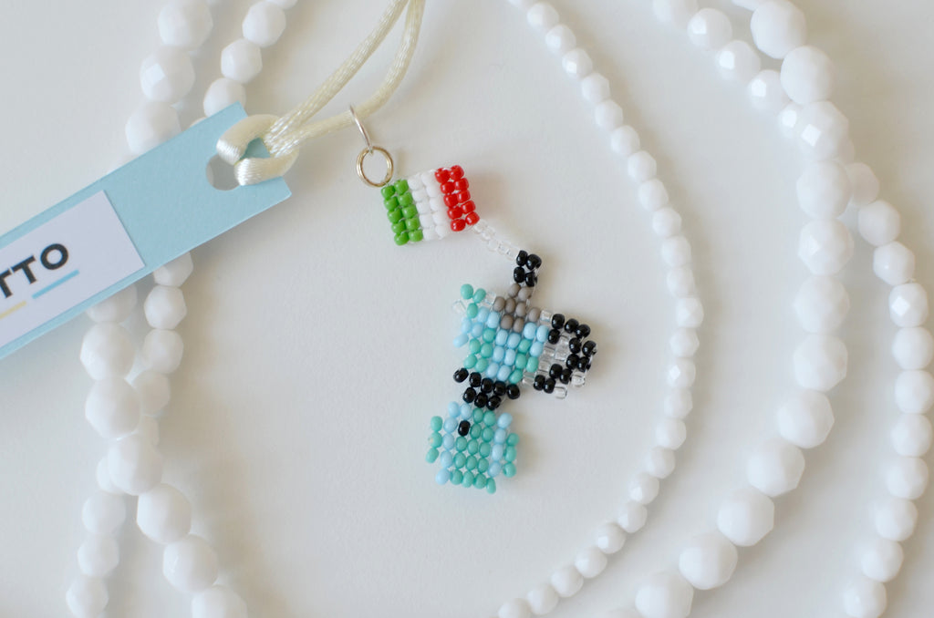 Beaded moka pot on a white beaded necklace with a SPOONITTO brand card