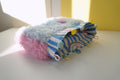 Colorful fluffy purse with pink, yellow and blue buttons