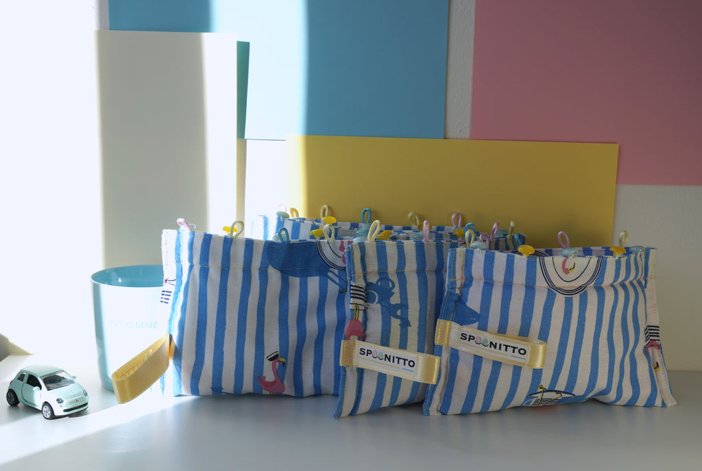 Blue and white striped purses with pink flamingos designs on a colorful wall background - SPOONITTO brand