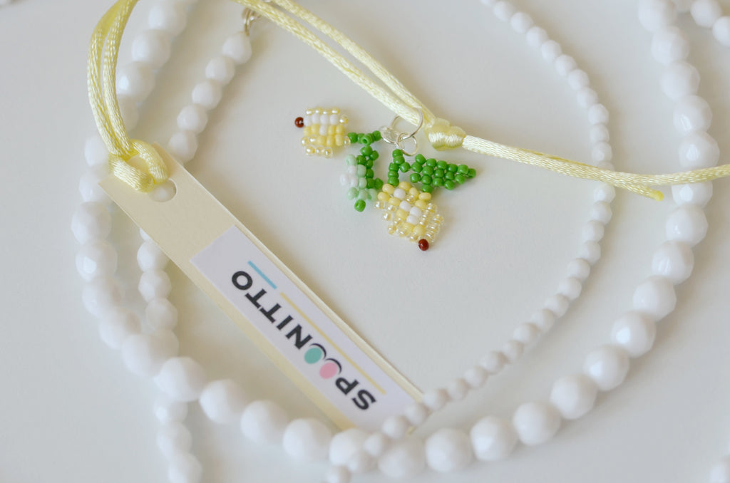 Necklace with a small lemon pendant on a white background
